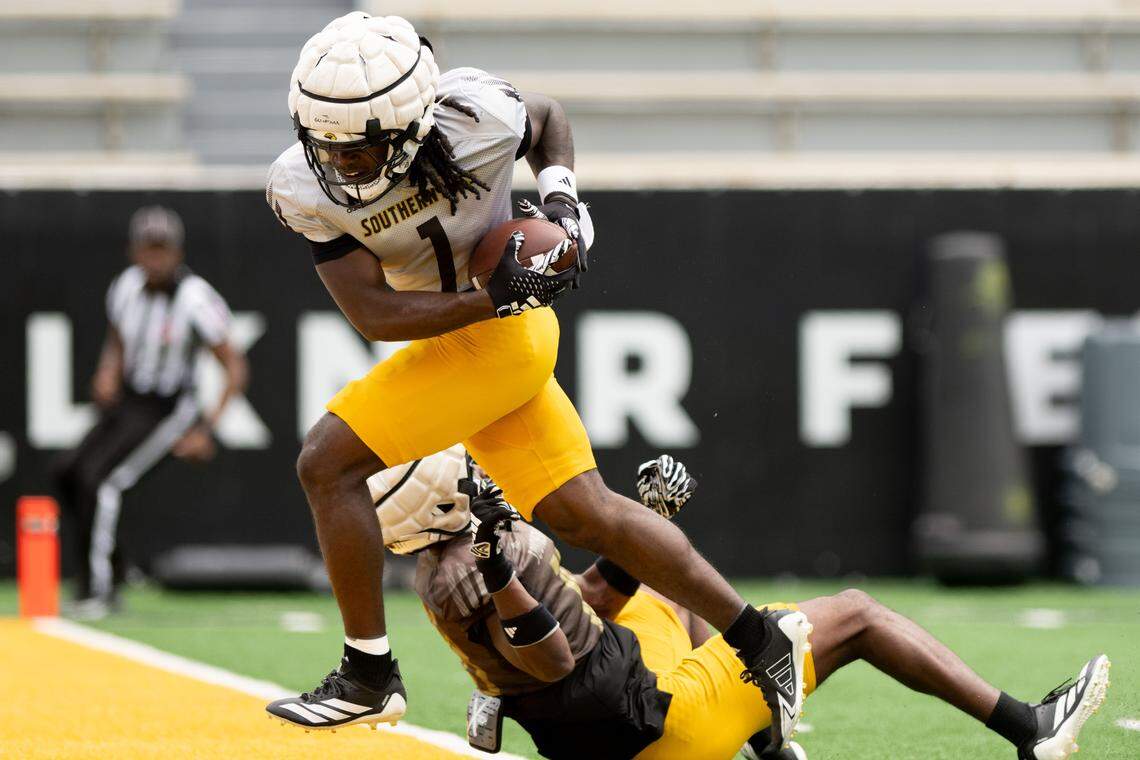 Southern Miss wide receiver Mario Sanders (1) sheds a tackle as he steps into the end zone Saturday.