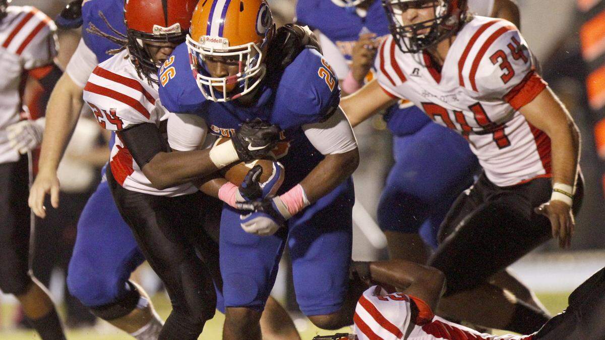 TIM ISBELL/SUN HERALD 
 A host of Harrison Central defenders try to bring down Gulfport running back Deon Cole..