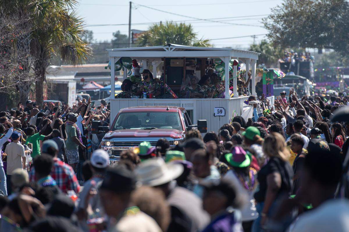 Krewes toss beads and other throws during the Jackson County Carnival Association Mardi Gras parade in Pascagoula on Saturday, March 1, 2025.