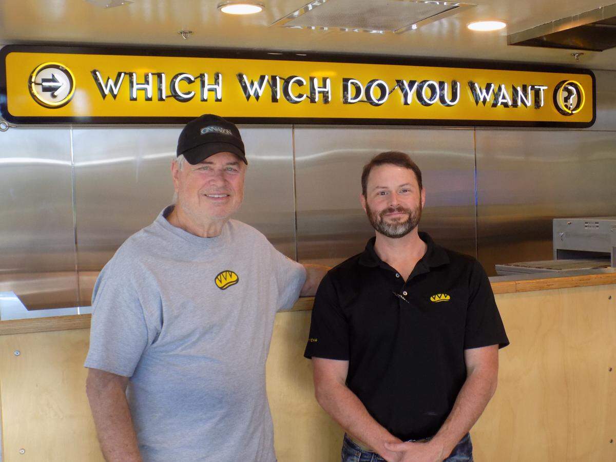 Father and son Mike Wells, left, and John Wells have reopened Which Wich sandwich shop in D’Iberville.