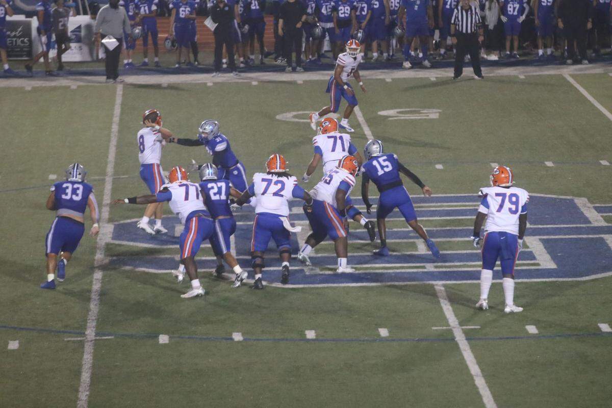 The Ocean Springs defense made life difficult for Gulfport quarterback Dane Sullivan (8) all night Friday, Nov. 1, 2024, during the Greyhounds’ victory over the Admirals.