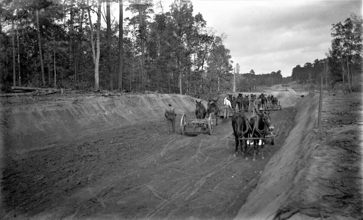 To create Gulfport and its port, the Gulf & Ship Island Railroad cut through the virgin pine forests of South Mississippi. This 1903 Willis W. Vail photograph shows the arduous work on the Columbia branch of the G&SI.