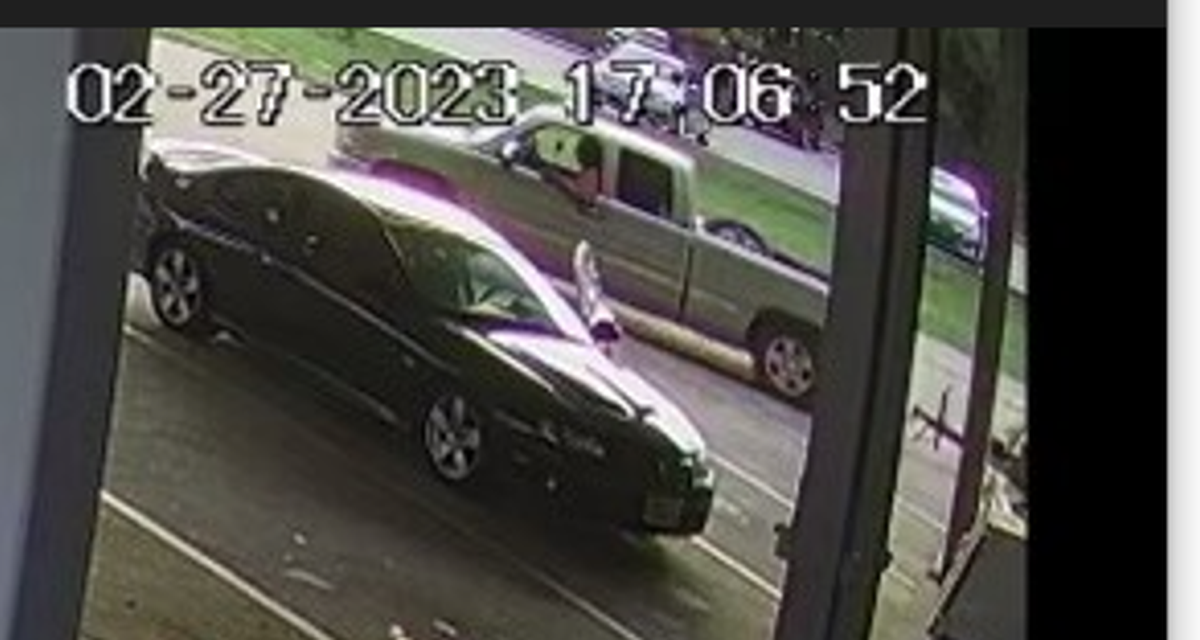 A store surveillance shows a man in a silver truck with an attached flatbed near the stolen car on February 27.