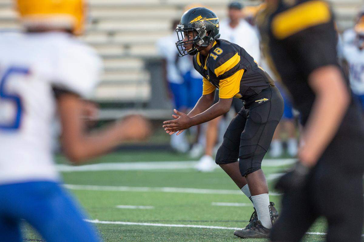 Tyler Hunter, the student manager for D’Iberville’s JV football team, takes the snap in a game against St. Martin at Warrior Stadium in D’Iberville on Monday, Oct. 9, 2023. Hunter, who has an intellectual disability, played for two of the game’s plays, scoring two touchdowns.