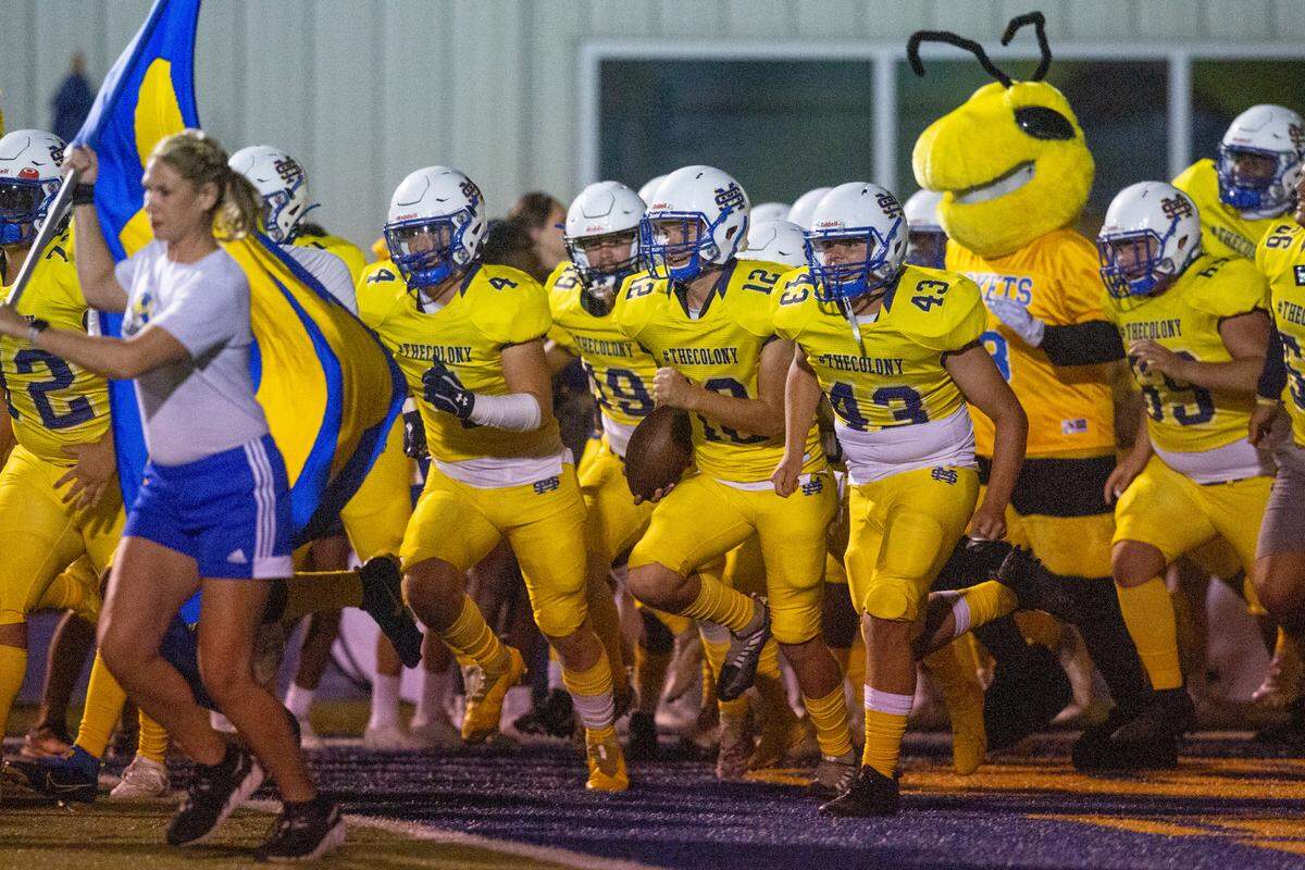 The St. Martin Yellowjackets run onto the field before a game against Hancock wearing special social media themed jerseys with their own hashtag and social media handles on them at Joe Barlow Stadium in St. Martin on Friday, Sept. 30, 2022.
