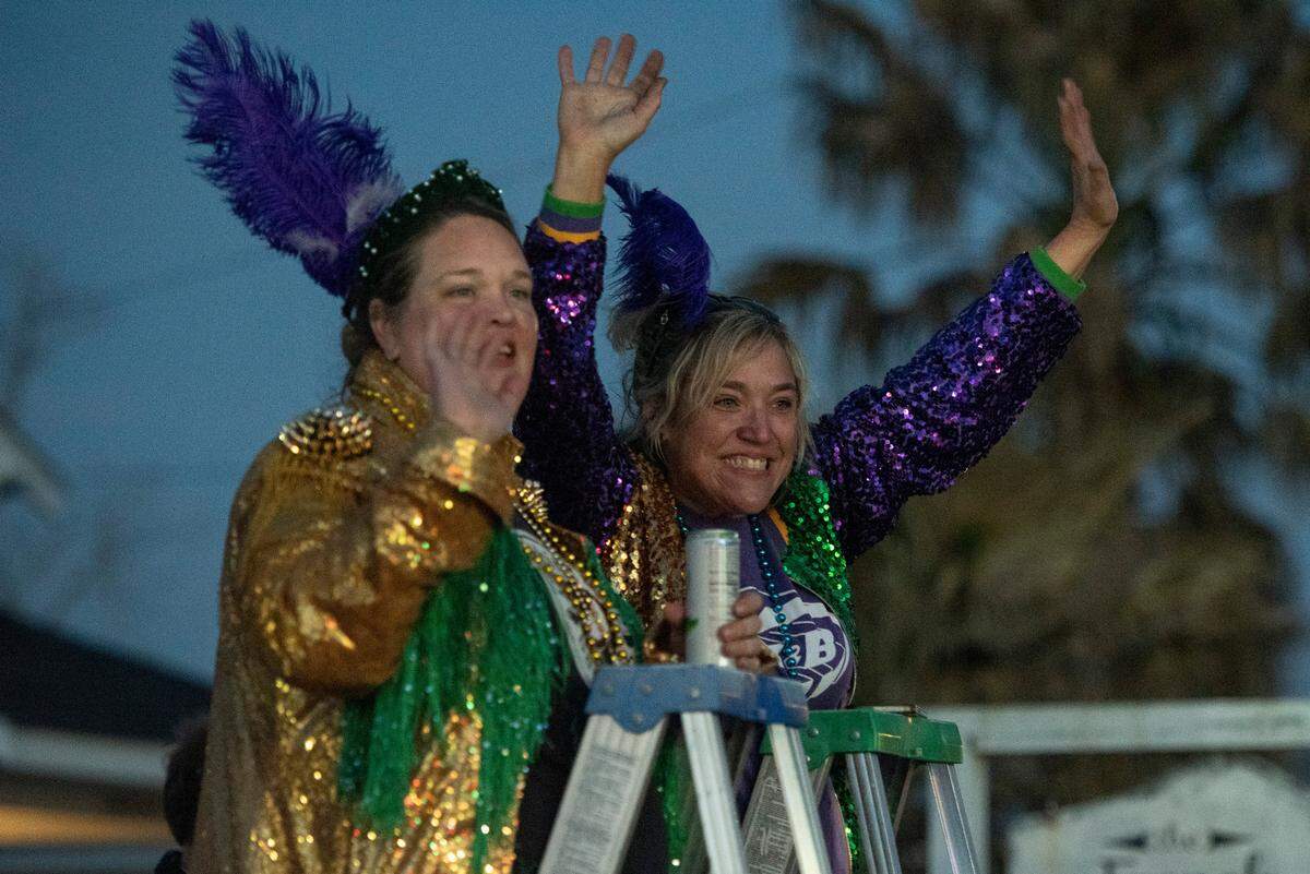 Parade watchers cheer for beads during Mystic Krewe of the Seahorse’s Lundi Gras parade in Bay St. Louis on Monday, March 3, 2025.
