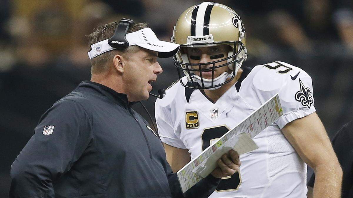New Orleans Saints head coach Sean Payton speaks to New Orleans Saints quarterback Drew Brees (9) during the first half of an NFL football game against the Atlanta Falcons, Thursday, Oct. 15, 2015, in New Orleans. (AP Photo/Gerald Herbert)