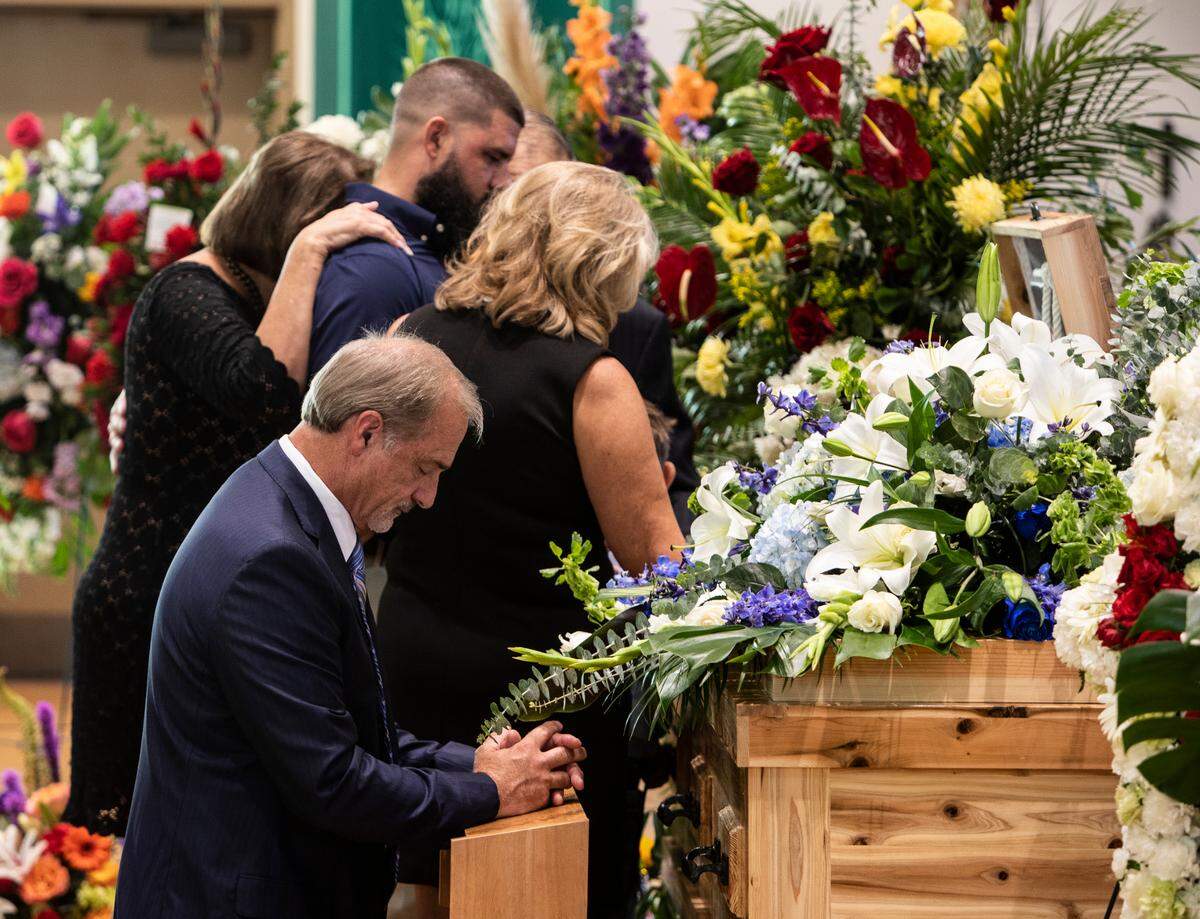 Bay St. Louis Councilman Doug Seal kneels and prays at the casket of his son, 28-year-old Cayce Seal, an Entergy lineman who died after an electric shock while working on power lines. Cayce’s funeral services were held at St. Clare Catholic Church in Waveland on July 1, 2021.