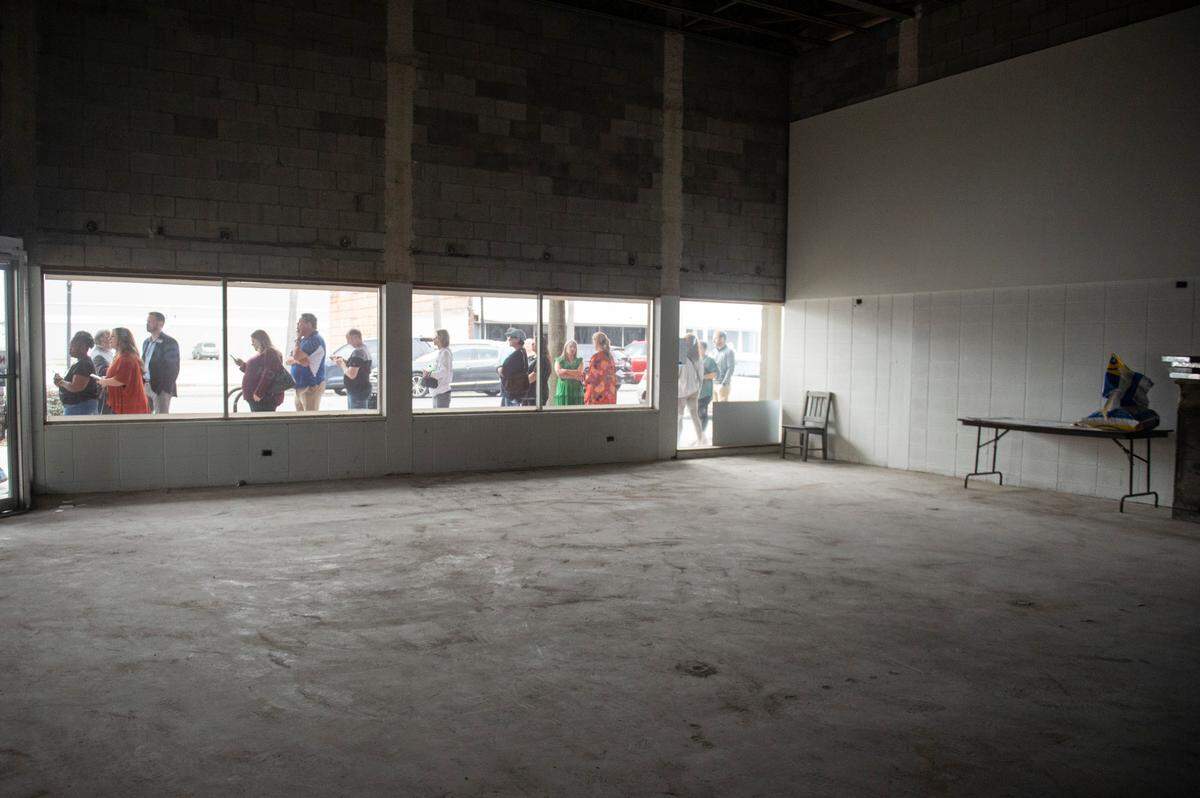 Customers line up to buy Loblolly Bakery king cakes during a pop-up sale outside the future site of The Downtowner restaurant on Friday, Feb. 7, 2025.