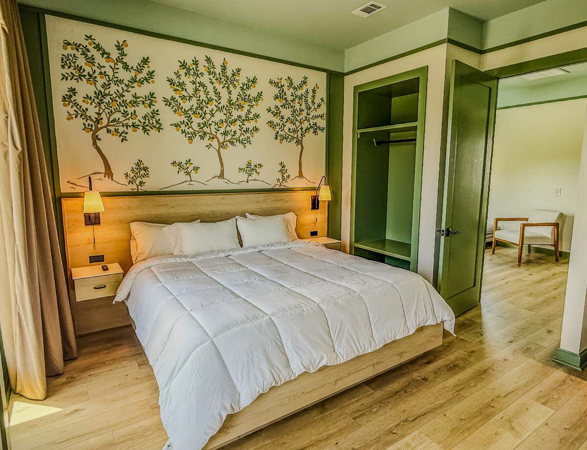 A king bedroom at the new Pass Bungalows in Pass Christian features handmade furniture, balconies or terraces with views of the great lawn or the harbor.