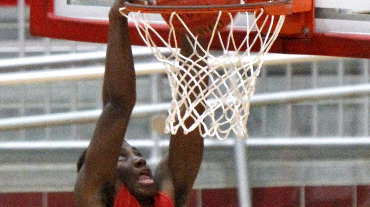 TIM ISBELL/SUN HERALDHarrison Central's Dayquan Perkins slams a dunk during game against D'Iberville, Friday, Dec. 18, 2015. 
