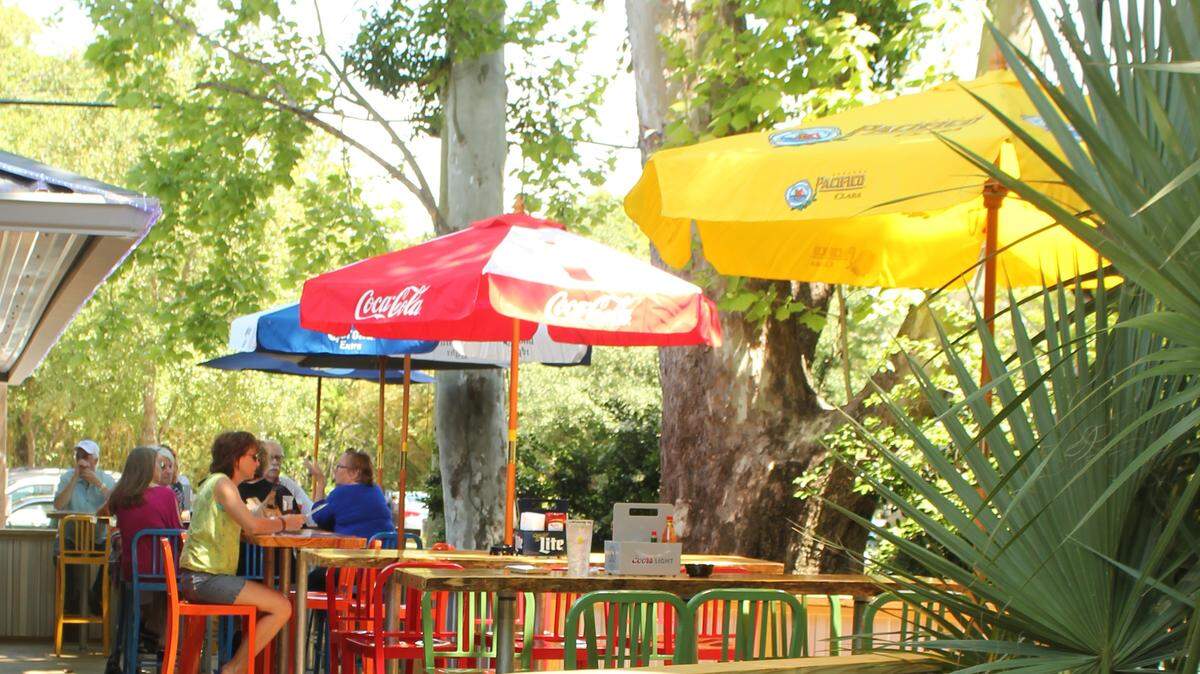 JULIAN BRUNT/SPECIAL TO THE SUN HERALDThe deck at Off the Hook in Ocean Springs is shaded by two large sycamore trees.