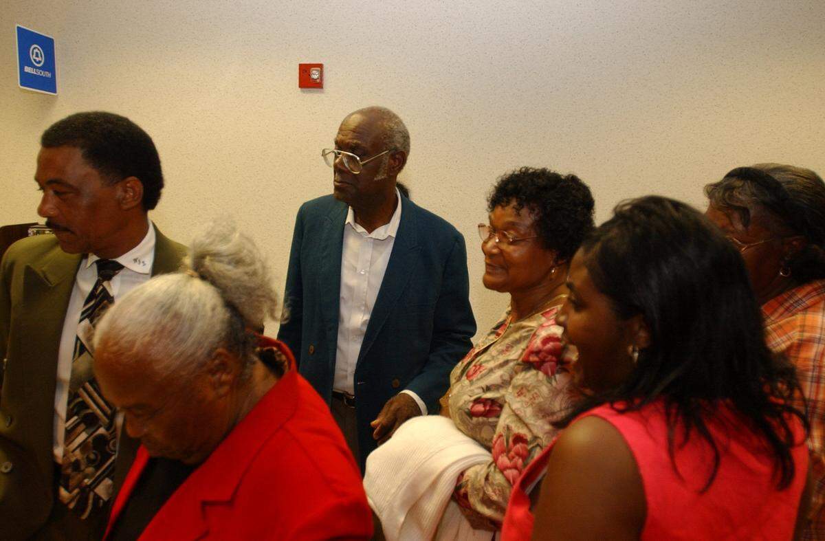 Connie Malone, center right, mother of deceased Marcus Malone, and others leave Jackson County court on Thursday, May 30, 2002, during a lunch break from testimony in the trial of Moss Point reserve officer Steve Strickler.