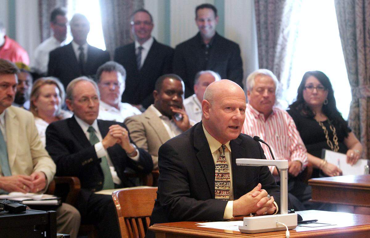 Ken Young, owner of four minor league baseball teams, talks to the Biloxi City Council on Thursday, September 12, 2013, about bringing his fifth team to Biloxi. Young is in the process of buying a franchise that could be moved to Biloxi. Tim Bennett, seated immediately behind Young, has filed a lawsuit against Young.