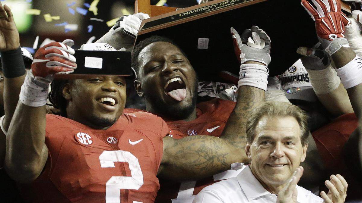 Alabama running back Derrick Henry (2) and Alabama head coach Nick Saban celebrate after the second half of the Southeastern Conference championship NCAA college football game against Florida, Saturday, Dec. 5, 2015, in Atlanta. Alabama won 29.15. (AP Photo/David Goldman)