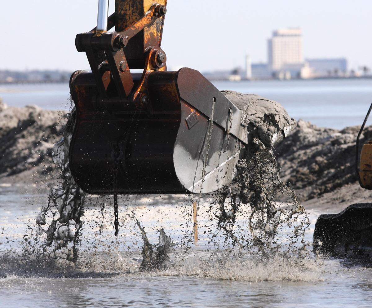 Crews worked on a dredge project in 2008 in Harrison County. The messy mixture of sand and water eventually became white sand beach after several days of exposure to the sun.