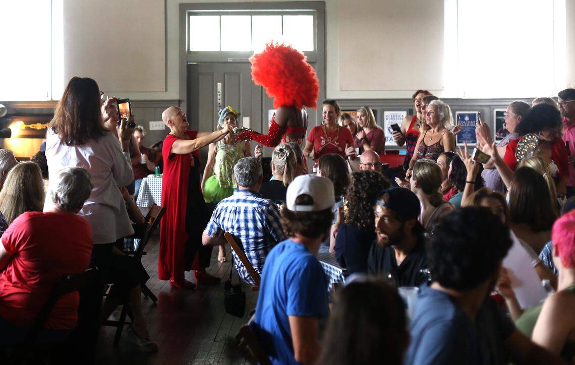 Rachel Dangermond, owner of 100 Men Hall in Bay St. Louis, tips Zamaryeah Dawn during drag brunch in June 2019.