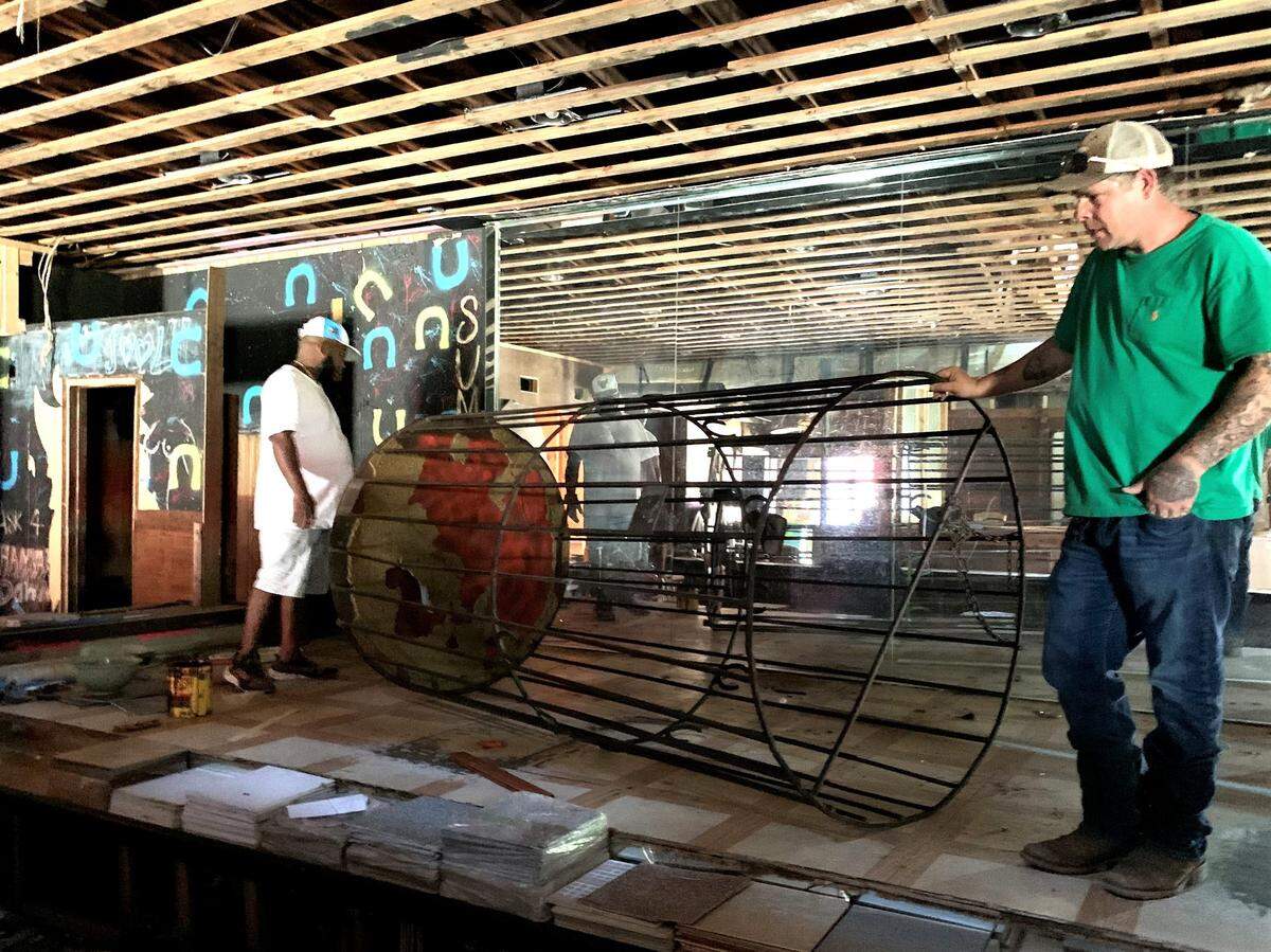 A dance cage, used during the heyday of the Lucky Horseshoe Lounge, is displayed by BJ Warden. He is the project manager overseeing the demolition of the club.