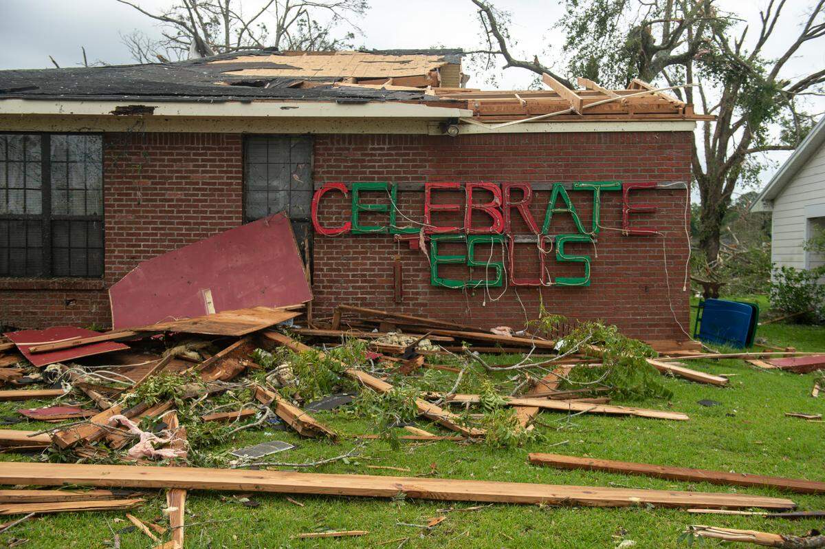 Part of a sign remains on a damaged home in Moss Point on Tuesday, June 20, 2023, after a tornado tore through the town on Monday.