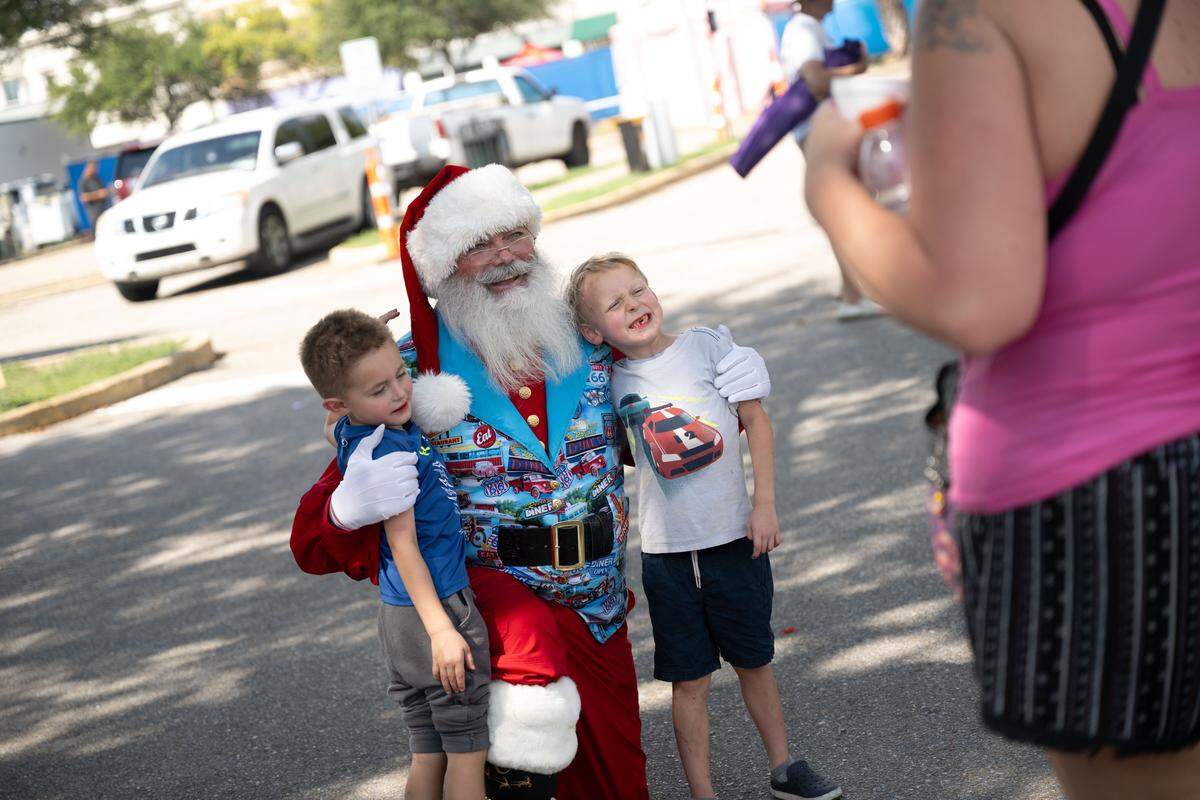 Children pose with Santa during the Biloxi Block Party.