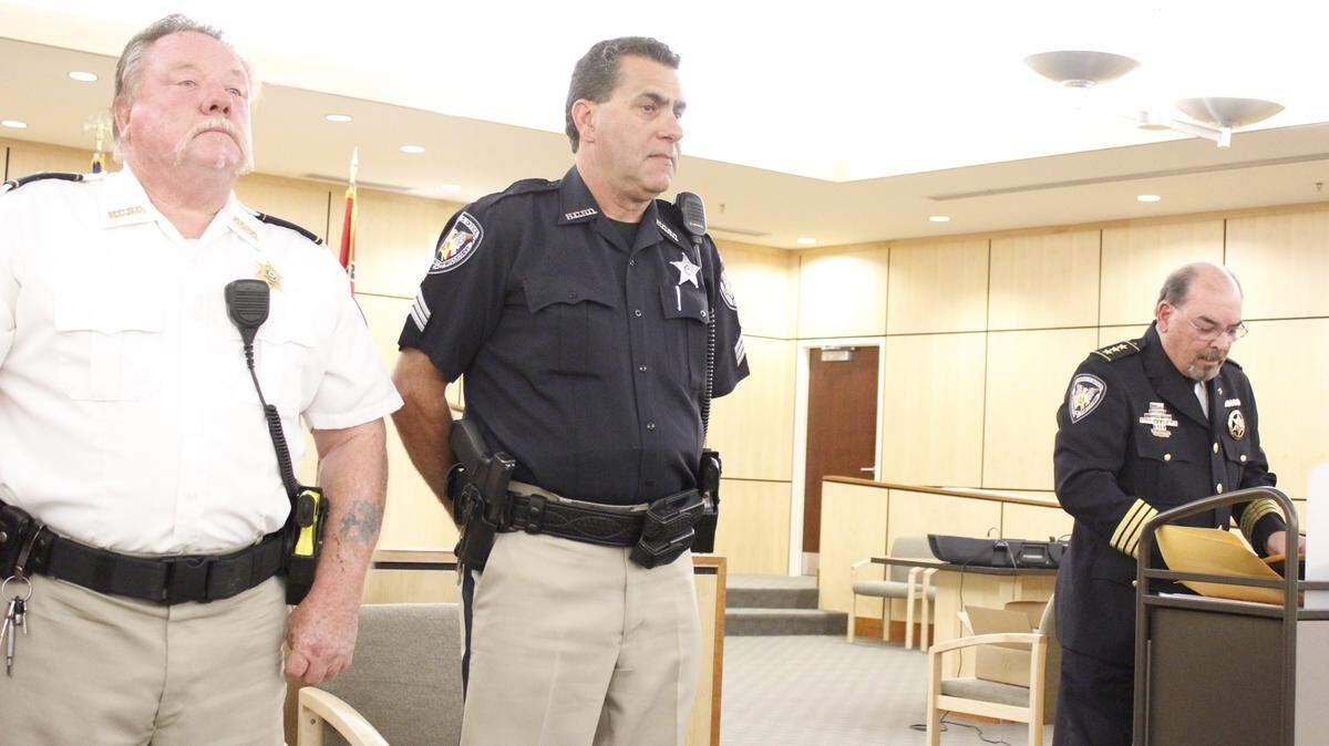 WESLEY MULLER/SUN HERALDFrom left, Lt. Edwin Merwin and Sgt. Thomas Bethea stand prepared to accept the Life Saving Ribbon at the Hancock County Sheriff's Office's awards ceremony Wednesday. Chief Deputy Don Bass, right, described their rescue of two young boys who had been kidnapped, sexually abused and almost killed.