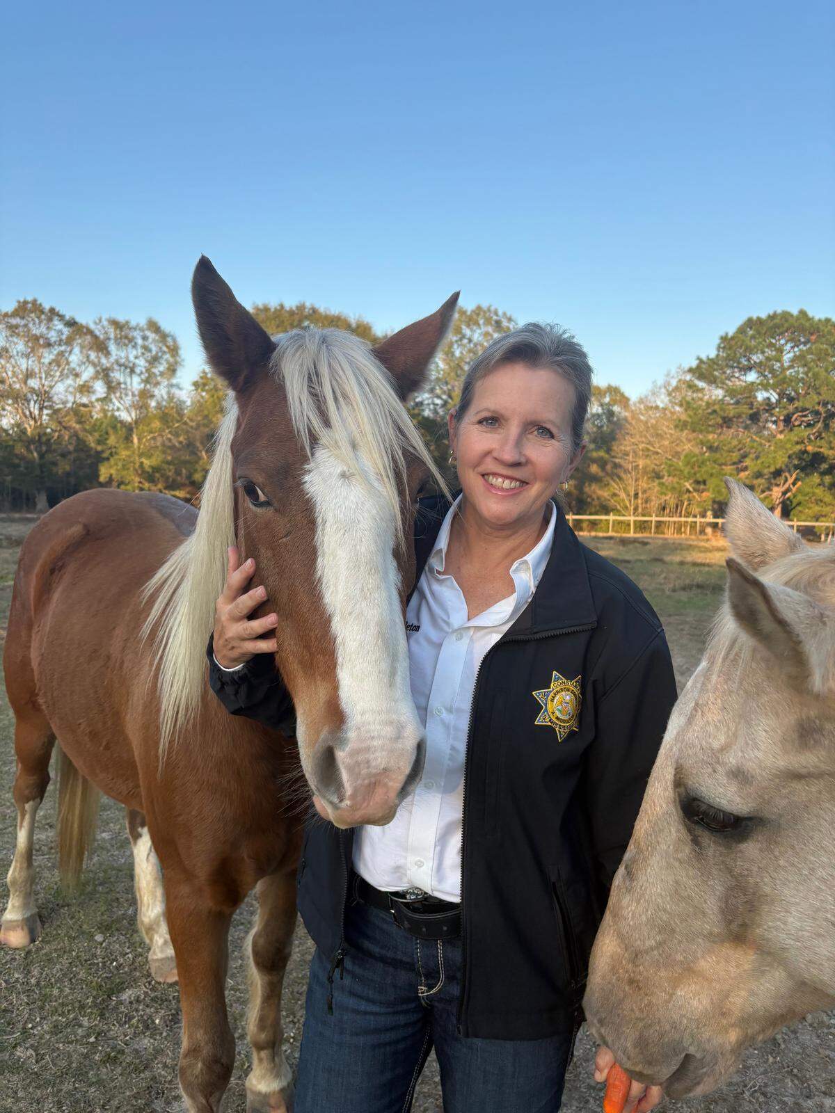 Angel Kibler-Middleton is shown on family land in unincorporated Harrison County with two of her horses. Kibler-Middleton and her group, Harrison County Strong, want to preserve the rural character of their community.