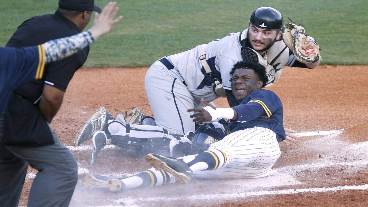TIM ISBELL/SUN HERALDMGCCC second baseman Marcus Buckley  and St. Louis catcher David Prost  plead their case as the umpire signals Buckley safe during first game of double header, Friday, Feb. 12, 2016. 