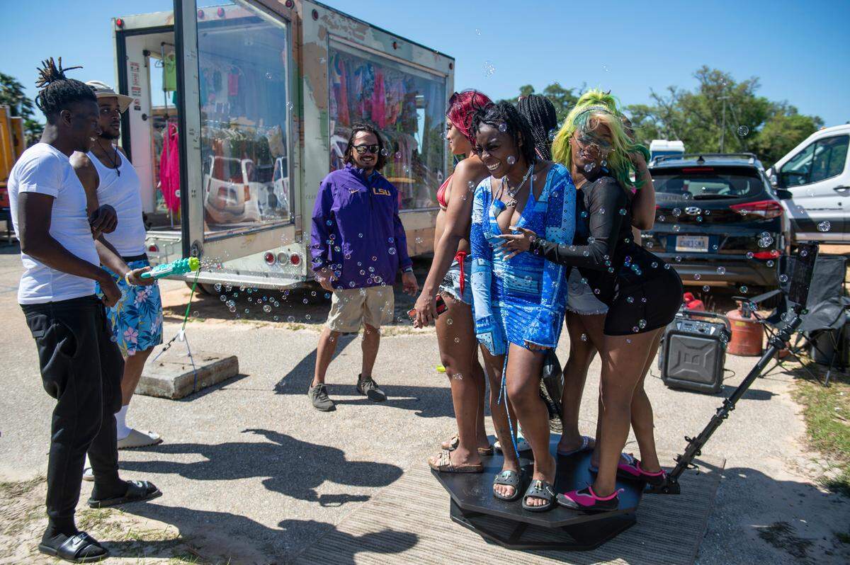 Spring breakers take a 360 degree photo offered by local business Full Circle Photos during Black Spring Break in Biloxi in 2022.