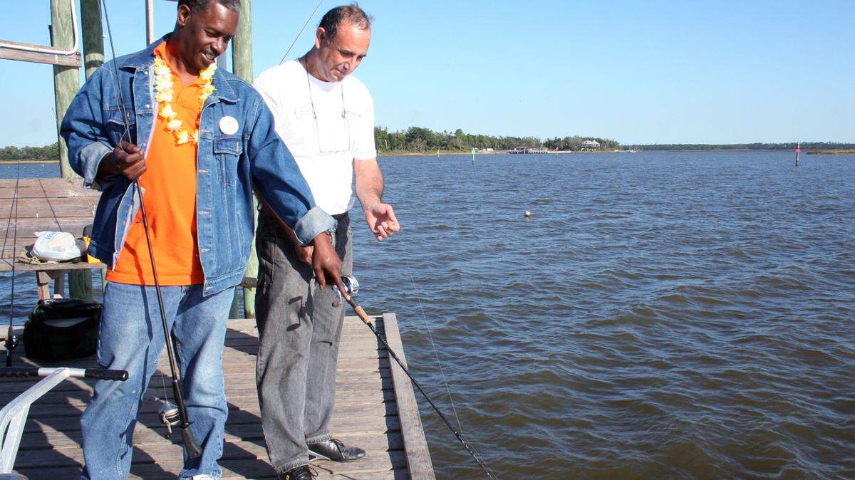 LEIGH COLEMAN/SPECIAL TO THE SUN HERALD/2010 
 Cancer survivors Rickey Chatman and Andy Farias team up to catch some fish at Camp Bluebird. Secretary of State Delbert Hosemann has ordered Ocean Springs-based MS Gulf Coast Bluebird Cancer Retreat to stop soliciting donations after his office found several violations of state law.