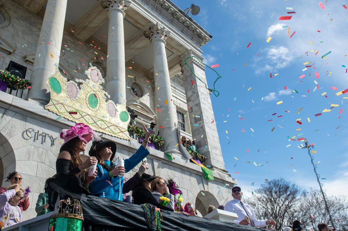 Paradegoers catch beads in front of city hall during the Gulf Coast Carnival Association’s Mardi Gras parade in Biloxi on Tuesday, Feb. 13, 2024.