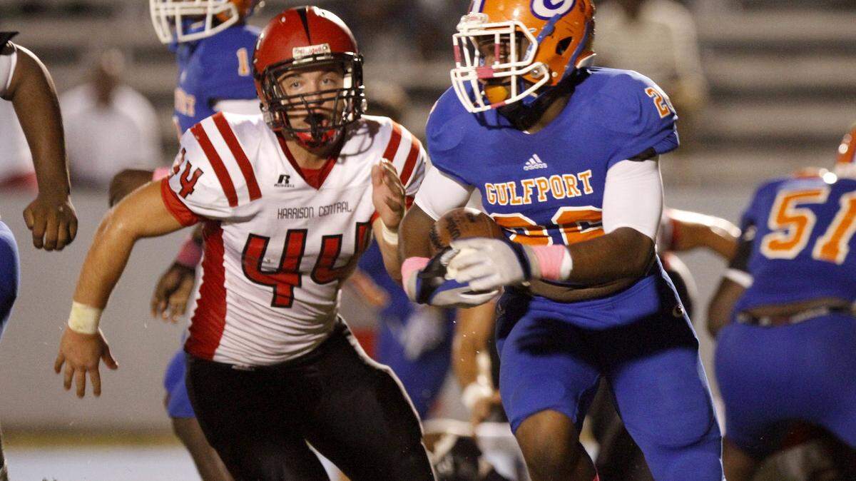 TIM ISBELL/SUN HERALD 
 Harrison Central's Aaron Rainey (44) chases down Gulfport running back Deon Cole.