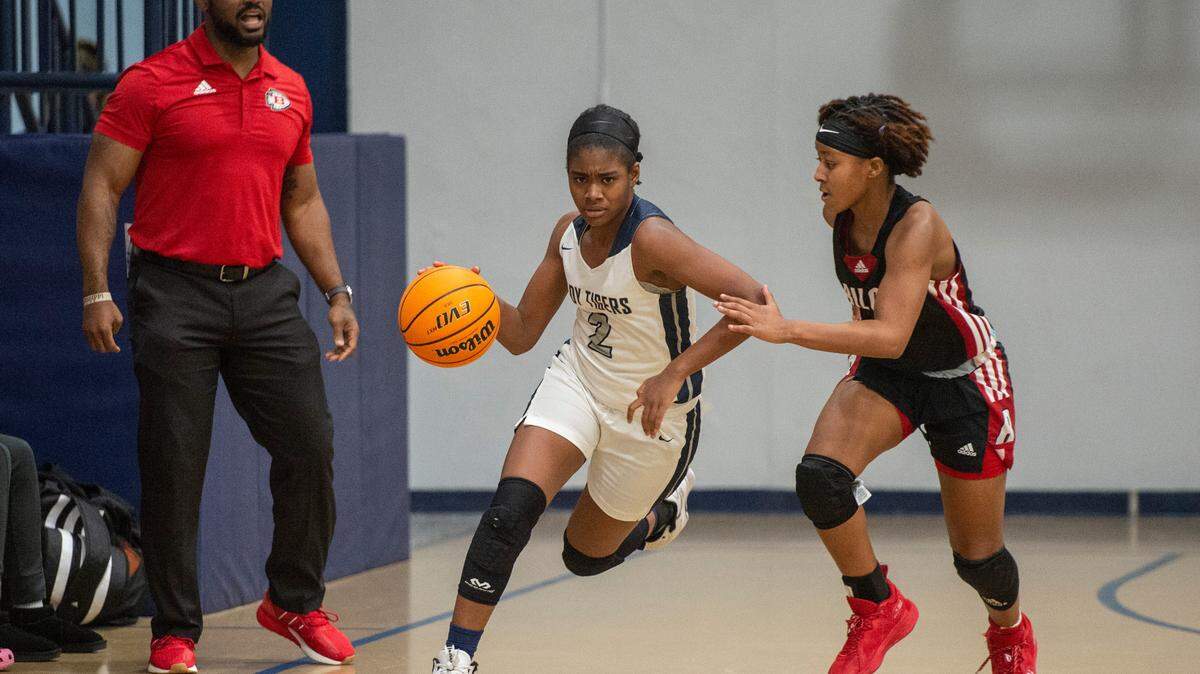 Moss Point’s Ar’yonna Miller dribbles the ball down the court past Biloxi’s Amiliyan Gines at Moss Point High School in Moss Point on Tuesday, Dec. 21, 2021.