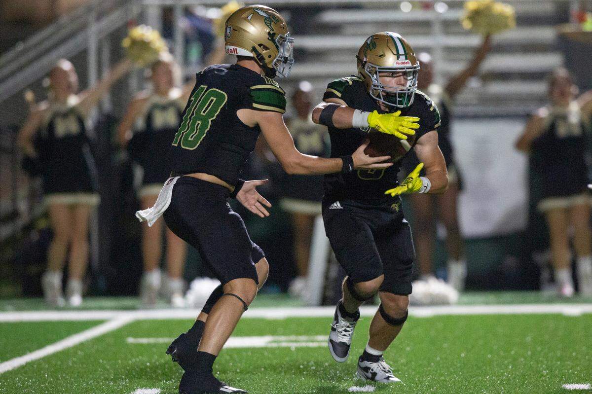 Poplarville’s Sydney Blackmon hands a pass off to Nick Miller during a playoff game between Poplarville and Mendenhall at Poplarville on Friday, Nov. 8, 2024.