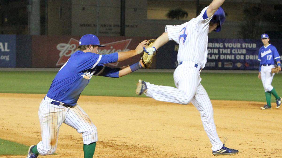 JOHN FITZHUGH/SUN HERALD 
 Ocean Springs first baseman James Noblin tags out Gulfport's Blake Johnson during the second inning of their game at MGM Park in Biloxi on Thursday March 17, 2016.