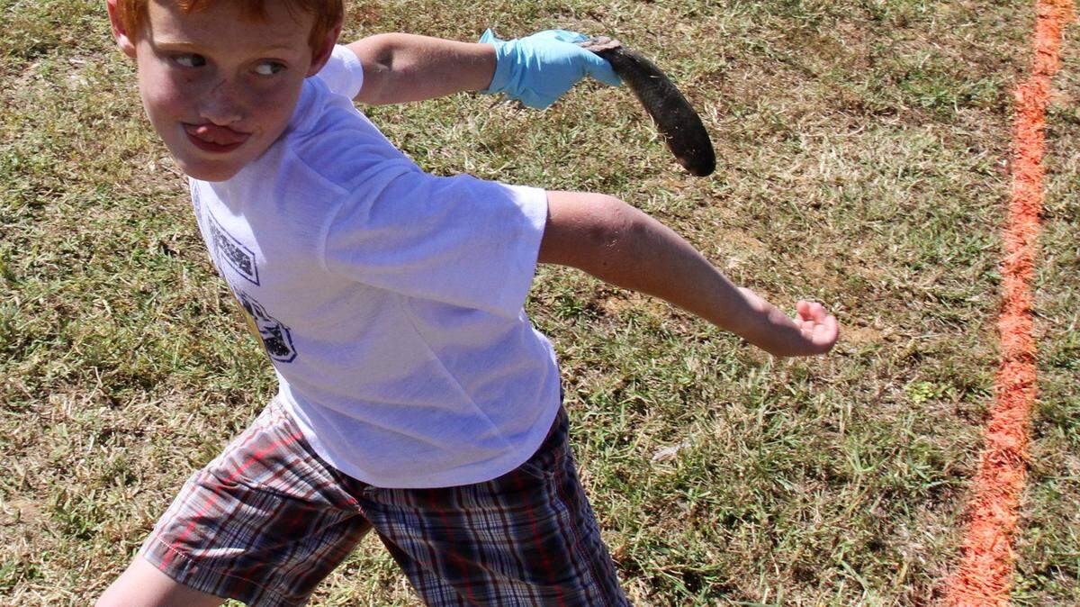 JOHN FITZHUGH/SUN HERALDAustin Busby of Gautier winds up for his throw in the mullet toss at a past Gautier Mullet Festival. This year's event will be Saturday and Sunday.