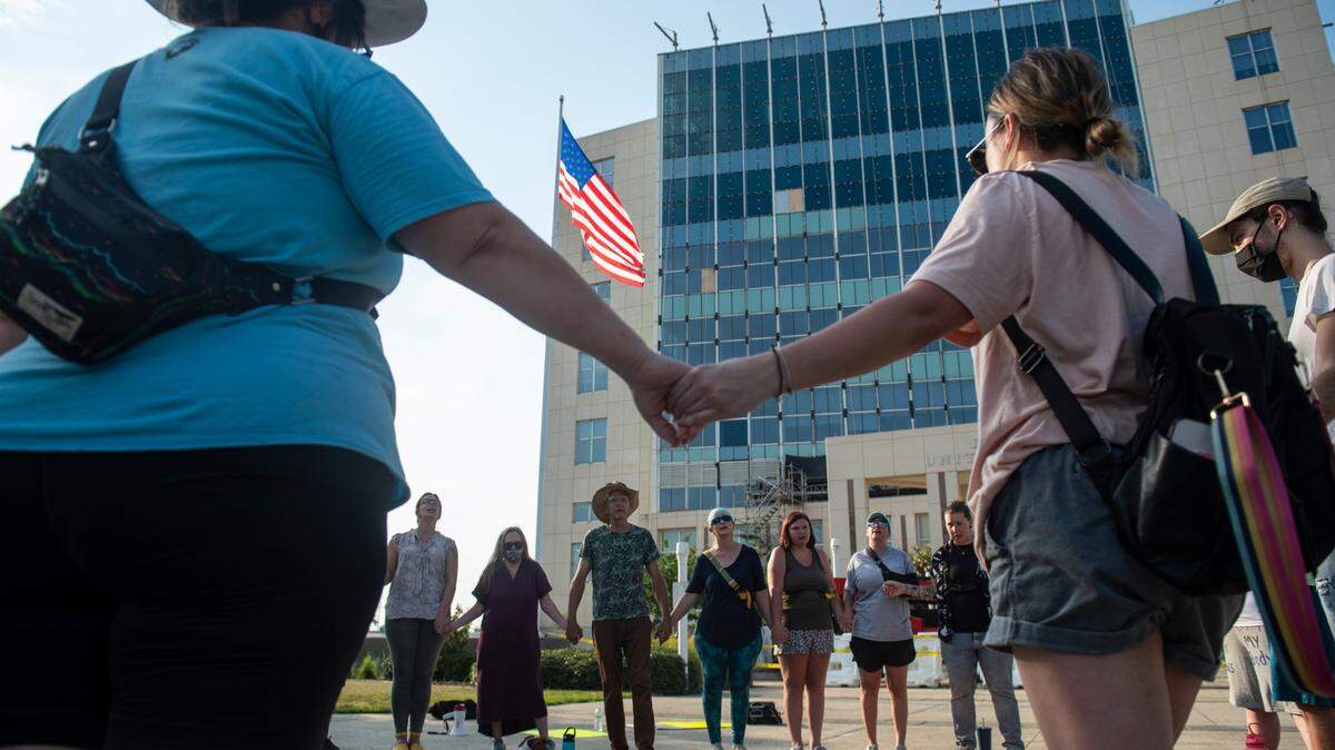 Abortion supporters hold hands during a protest against the Supreme Court Dobbs vs Jackson Women’s Health decision that reversed Roe vs Wade outside Dan M. Russell Jr. Courthouse in Gulfport on Friday, June 24, 2022.