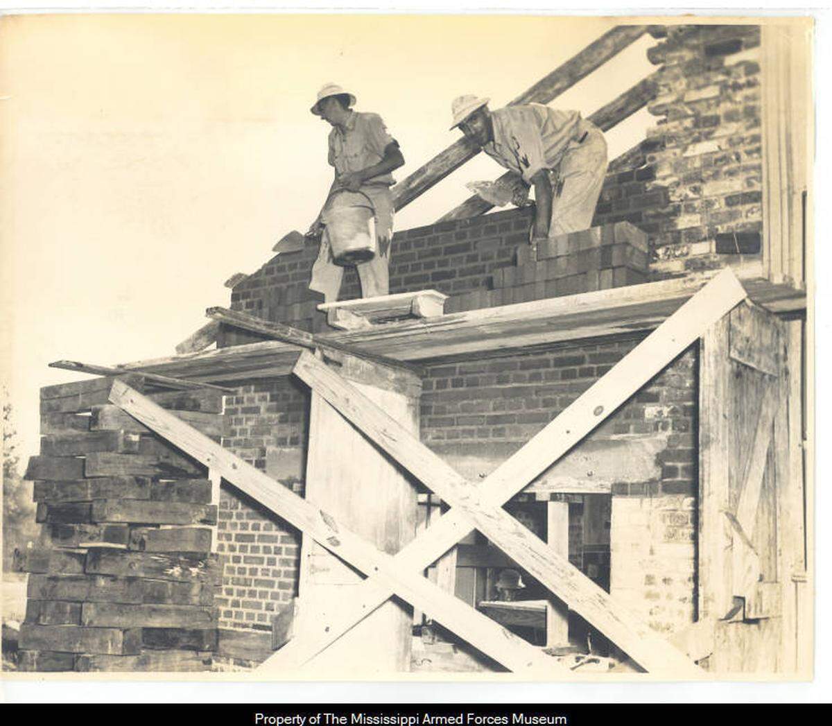 German prisoners of war laying bricks as part of a work detail.
