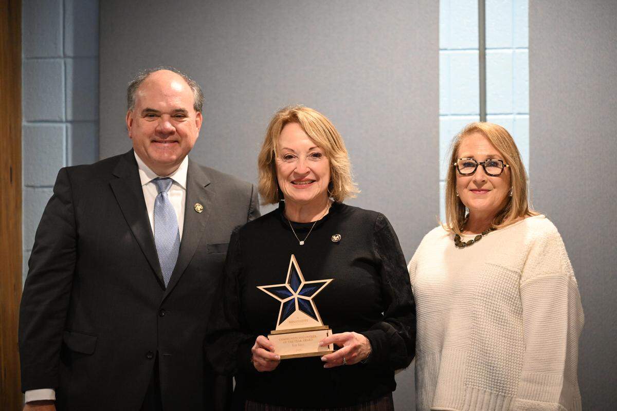 Kell Kell, center, is presented her award for Mississippi’s Community Volunteer of the Year at Friday’s Southern Rail Commission meeting in Bay St. Louis. Ross Knox, the chairman of the SRC, and Judy Young, executive director of Coastal Mississippi, congratulate Kell on her award.