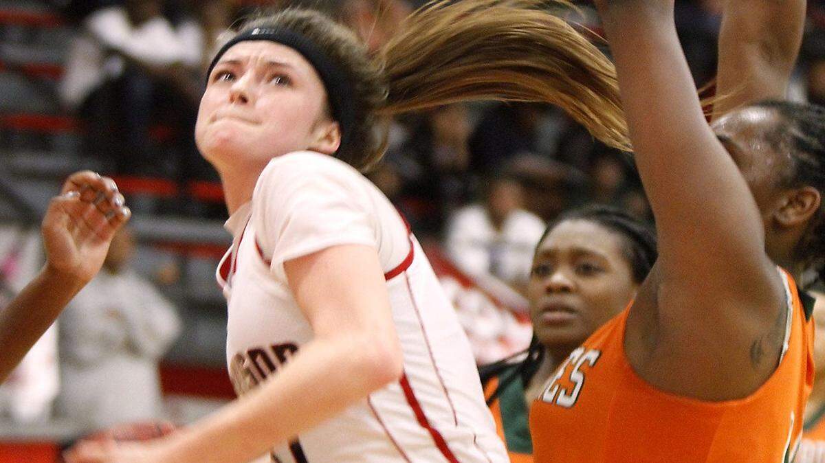 TIM ISBELL/SUN HERALD 
 Harrison Central's Adyn Strickland takes the ball to the hoop as Ameshya Williams of West Harrison defends, Tuesday, Feb. 2, 2016.