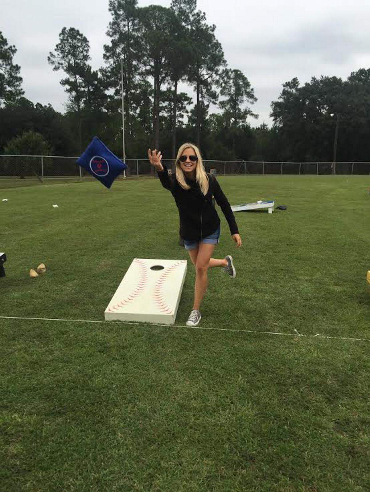 COURTESY CHARLOTTE BRADFORD  Katie Russell competes during the Pass Christian baseball team's cornhole tournament.