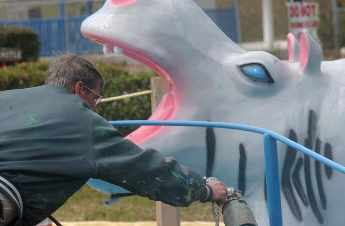 Roland Ladner of Gulfport paints a hand rail at FunTime USA in Gulfport in 2005. The amusement park was destroyed by Hurricane Katrina that August.