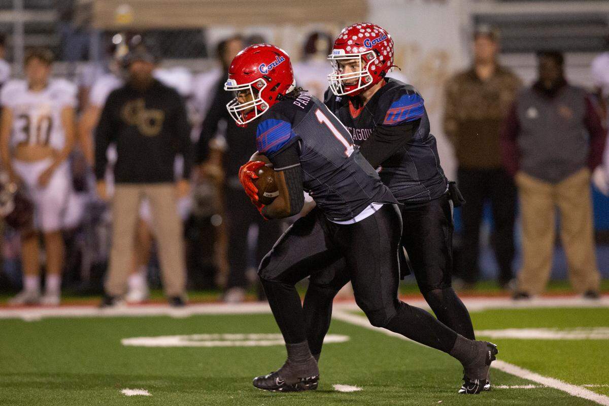 Pascagoula quarterback Silas Corder hands off the ball during a game against George County at Pascagoula High in Pascagoula on Thursday, Nov. 2, 2023.