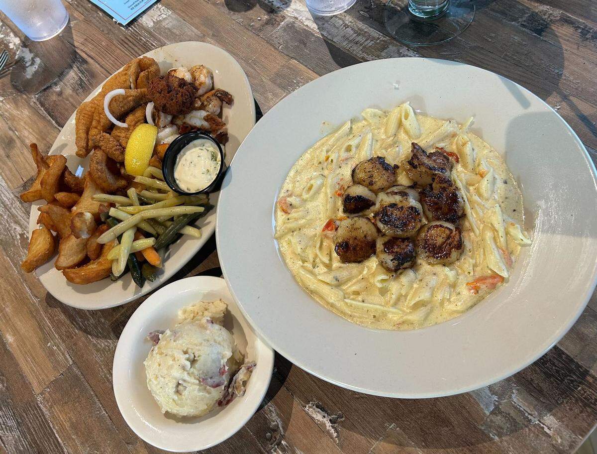 The alfredo with scallops and seafood combo plate at Flatheads and Bottomfeeders Catfish and Steaks in Biloxi, Mississippi.