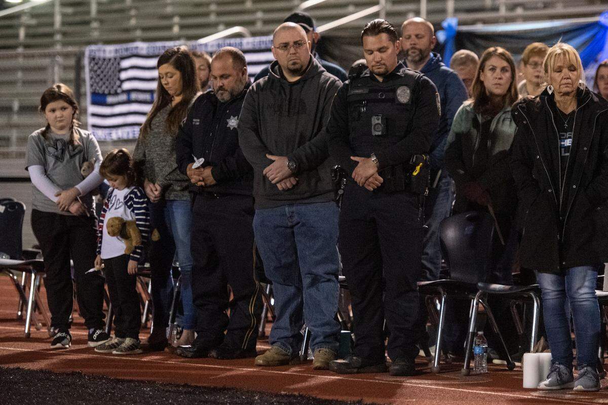 Law enforcement and family members during a candlelit vigil for Bay St. Louis Sgt. Steven Robin and officer Branden Estorffe at Tiger Stadium in Bay St. Louis on Thursday, Dec. 15, 2022. Robin and Estorffe were killed on Wednesday when a woman shot both of them.