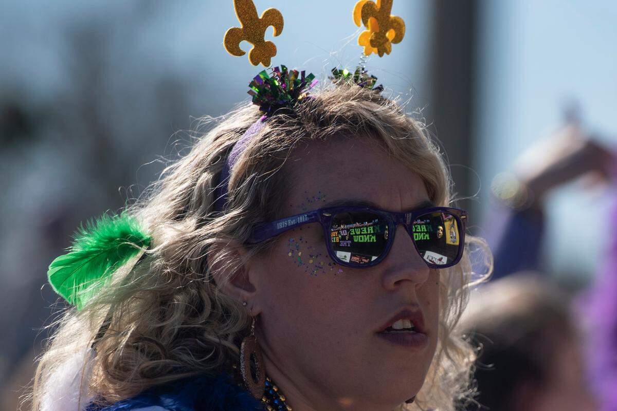 A float is reflected in a parade watcher’s glasses during the Krewe of Nereids Mardi Gras parade on Highway 90 in Bay St. Louis on Sunday, Feb. 12, 2023.