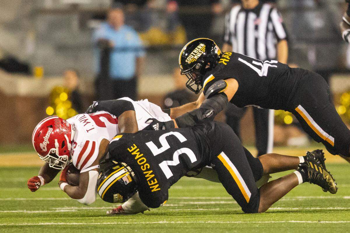 Southern Mississippi linebacker TQ Newsome (35) tackles Louisiana-Lafayette running back Terrence Williams (23) during the second half of an NCAA college football game in Hattiesburg, Miss., Thursday, Oct. 27, 2022. (Hannah Ruhoff/The Sun Herald via AP)