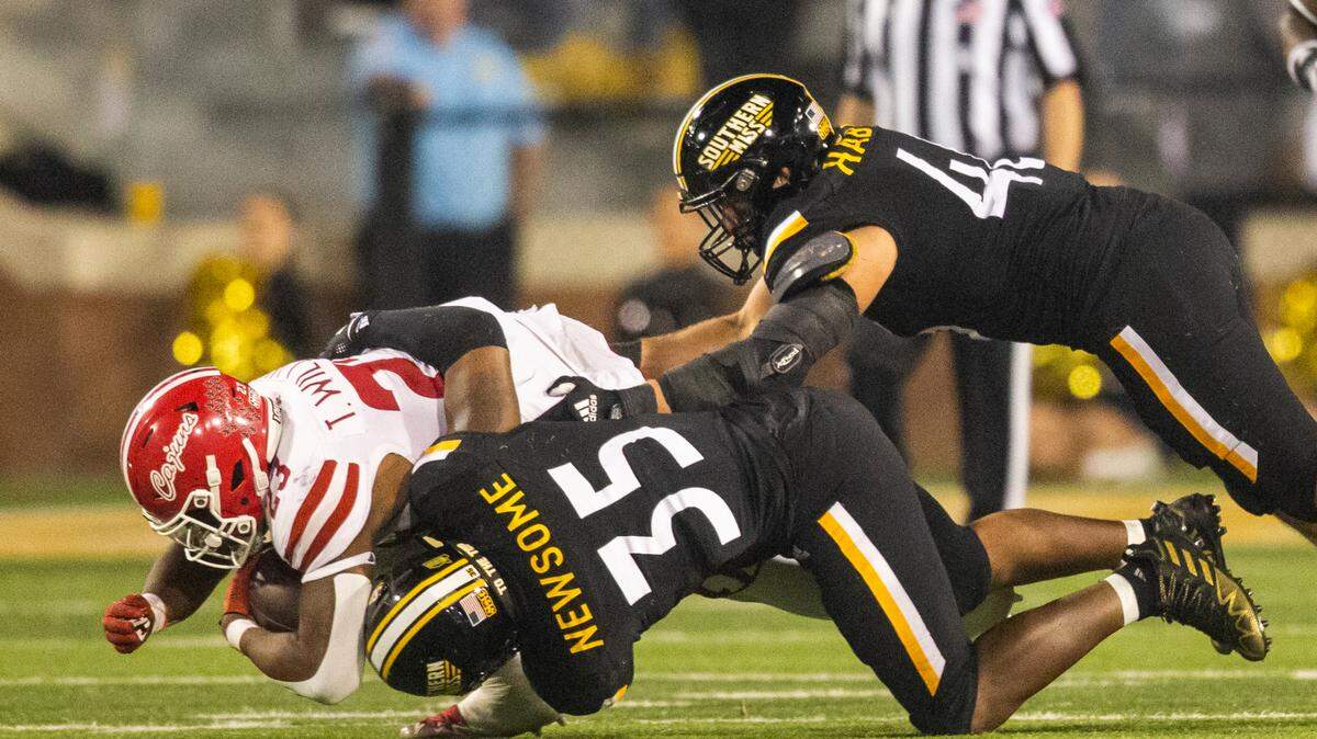 Southern Mississippi linebacker TQ Newsome (35) tackles Louisiana-Lafayette running back Terrence Williams (23) during the second half of an NCAA college football game in Hattiesburg, Miss., Thursday, Oct. 27, 2022. (Hannah Ruhoff/The Sun Herald via AP)