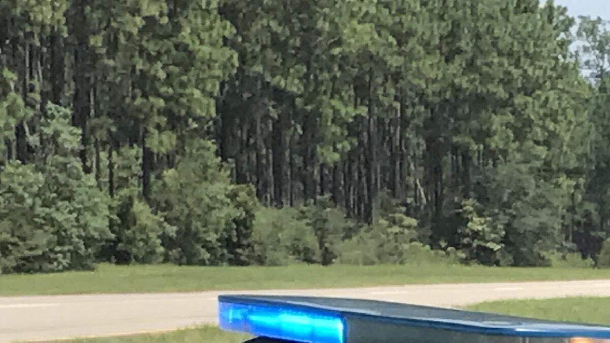 A Harrison County sheriff's department vehicle sits on Hwy. 605 near the scene of a shooting.