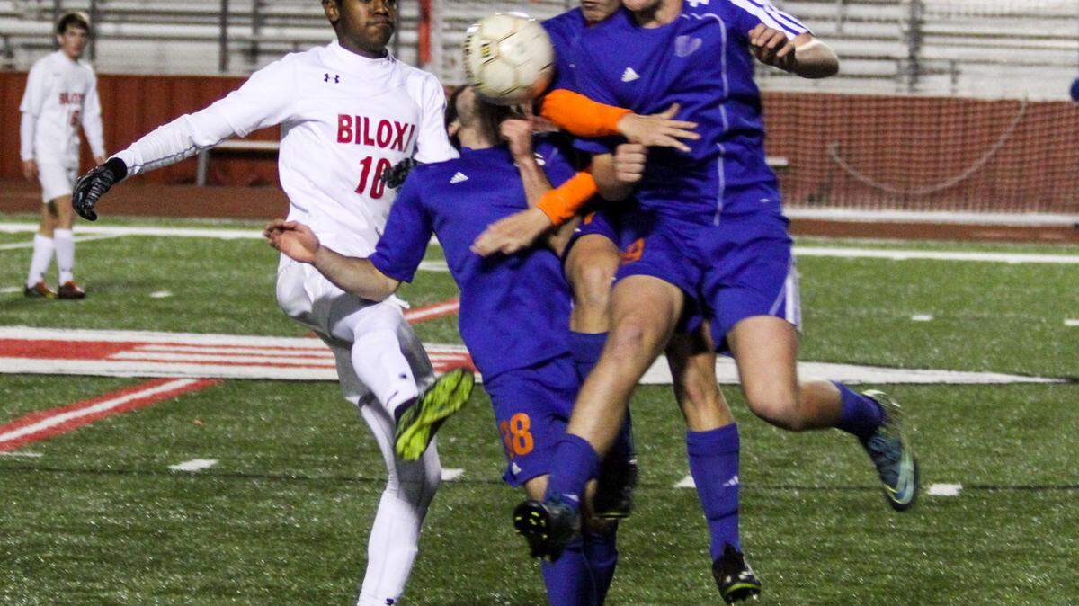 CHRISTOPHER BOSTICK/SUNHERALD 
 Biloxi's Marcus Kennedy, left, collides with several Gulfport players going for a loose ball. Both teams have advanced to the second round of the Class 6A playoffs.