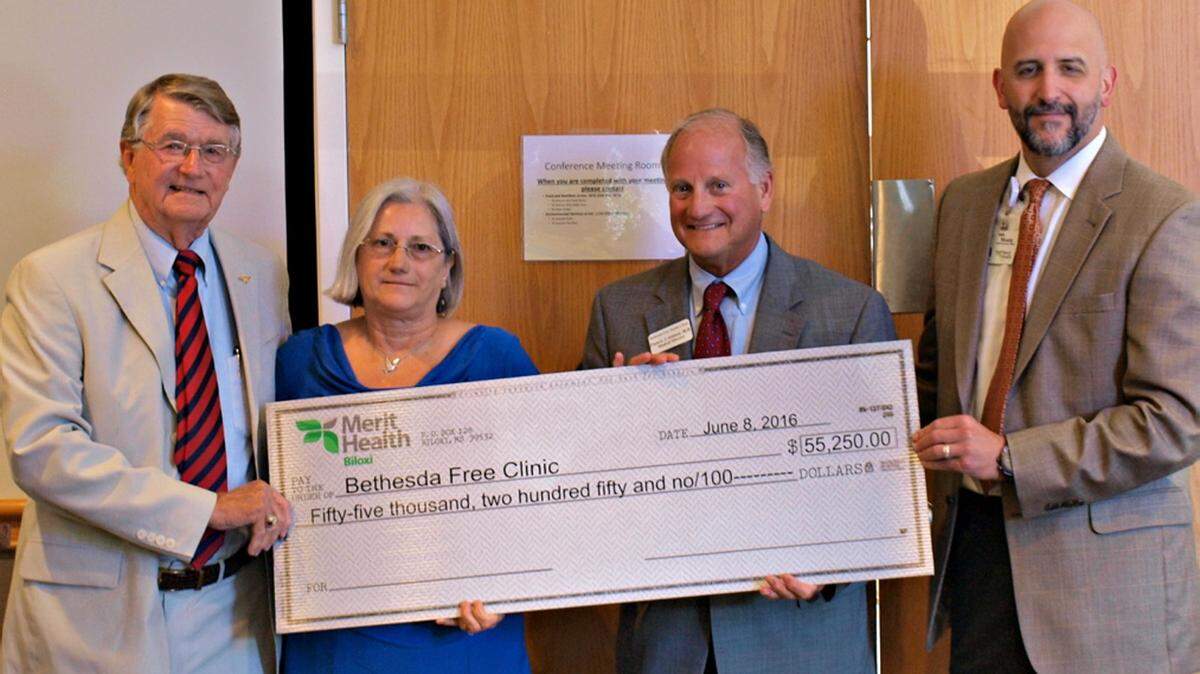 MERIT HEALTH BILOXIRob Briscoe, chairman of the board of Merit Health Biloxi, left, and CEO Monte Bostwick, right, present a check to representatives of Bethesda Free Clinic. The medical center gave $330,000 in donations to local charities Wednesday, June 8, 2016.